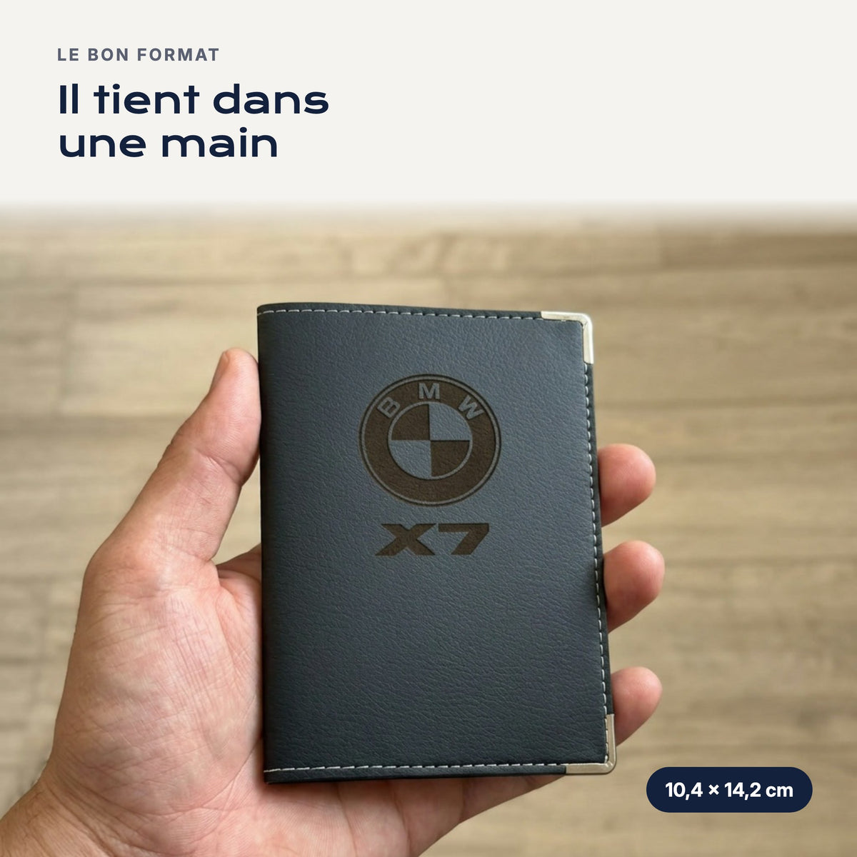 Porte-carte grise BMW X7 en simili cuir tenu dans une main