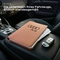 Fahrzeugmappe Audi A3 auf einem Autositz, mit Rechnungen